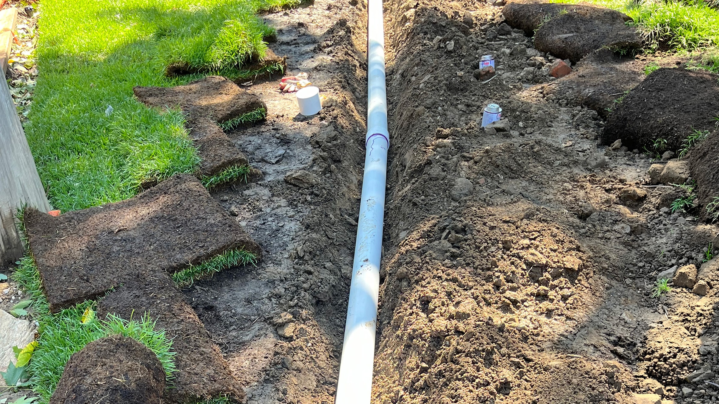 Installation of drainage pipe redistributing water runoff for increased natural irrigation and flood prevention