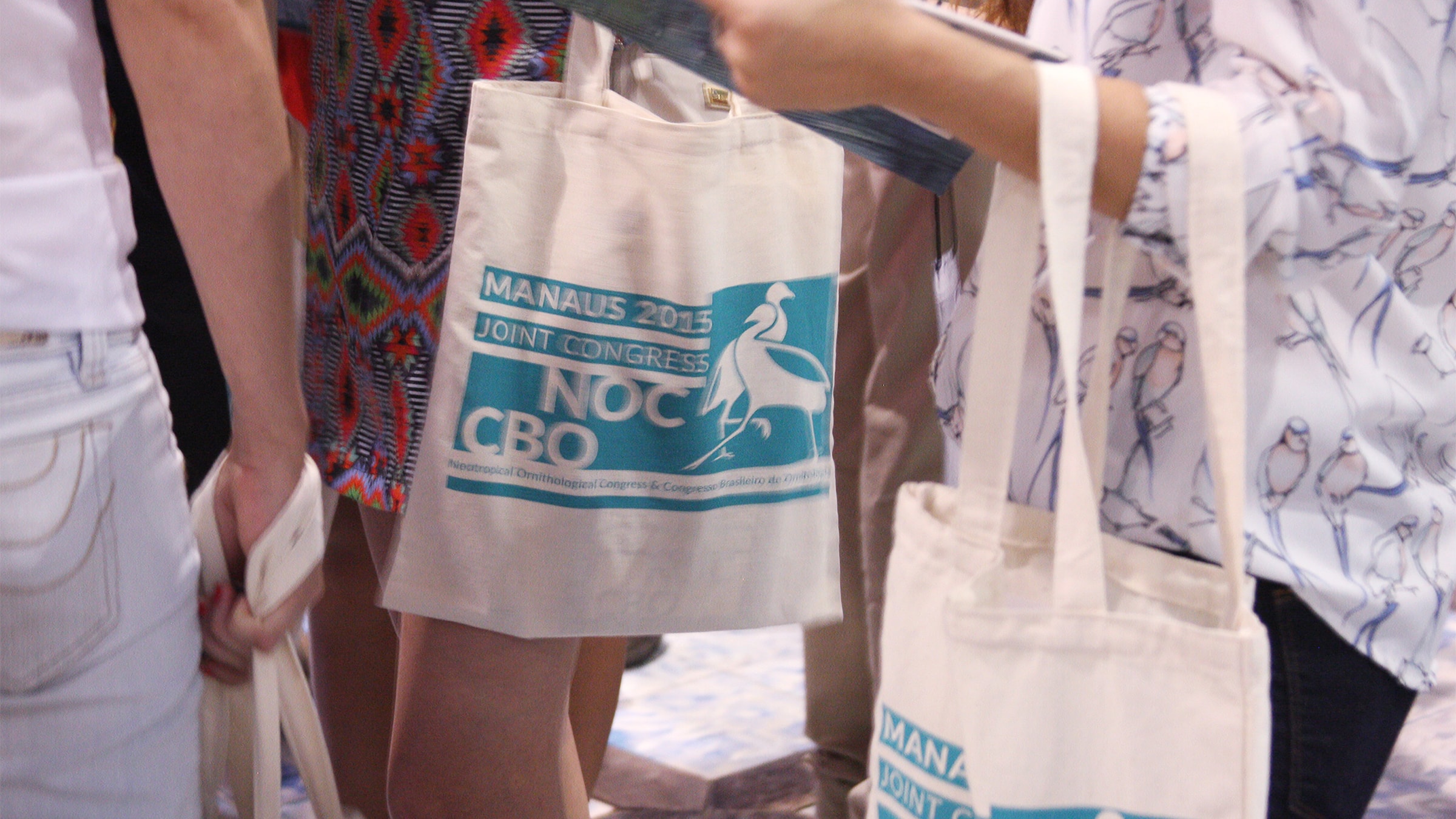 Screen-printed welcome tote bag for carrying event program and other assets